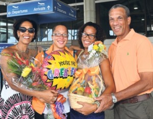 BUOYANT BOYEAS: (from left) mum Susan, Krystal, sister Kayla and dad, Cally welcoming Krystal home after she climbed Mount Kilimanjaro in Tanzania. (Picture by Kenmore Bynoe.) From the Nationnews.com