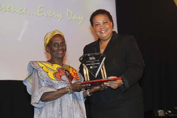 Gerda Gosepa. Caption: Regional Unsung Hero 2012, Gerda Gosepa (left) proudly and happily collects her award from Managing Director, HR, CIBC FirstCaribbean, Ella Hoyos.
