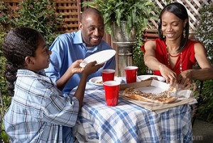 African family eating Pizza Photo courtesy wwwvisualphotoscom