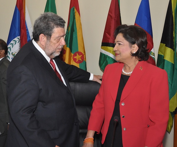 Outgoing chair Kamla Persad-Bissesar chats with incoming chair Ralph Gonsalves ((photo by Kingsley Roberts)