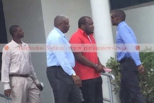 CEO of Phoenix Airways Neville Gumbs (second right) was arrested by police at his Hastings, Christ Church office yesterday. Photo courtesy http://www.nationnews.com