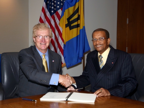 Stephen P. Holmes, Chairman and Chief Executive Officer, Wyndham Worldwide, and Everton Walters, Chairman, Barbados Tourism Investment Inc., finalize agreement to develop 450-room Sam Lord's Castle Barbados, A Wyndham Grand Resort. (PRNewsFoto/Wyndham Hotel Group)
