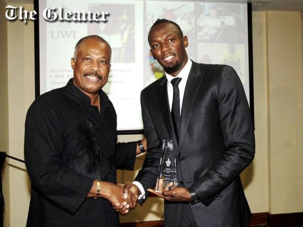 UWI Vice Chancellor Professor Sir Hilary Beckles (left) presents Dr The Hon Usain Bolt, OJ, Olympian, with the inaugural Vice Chancellor’s Alumni Exemplar Sports Award at a ceremony at the Regional Headquarters of the University of the West Indies (UWI), Mona, yesterday. Photo courtesy http://jamaica-gleaner.com/