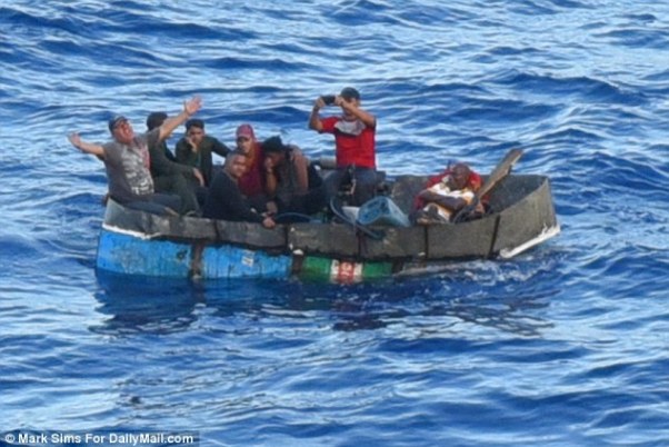 The refugees were floating on a row boat that appeared to be attached to barrels, with backpacks and paddles inside. Photo courtesy http://www.dailymail.co.uk/