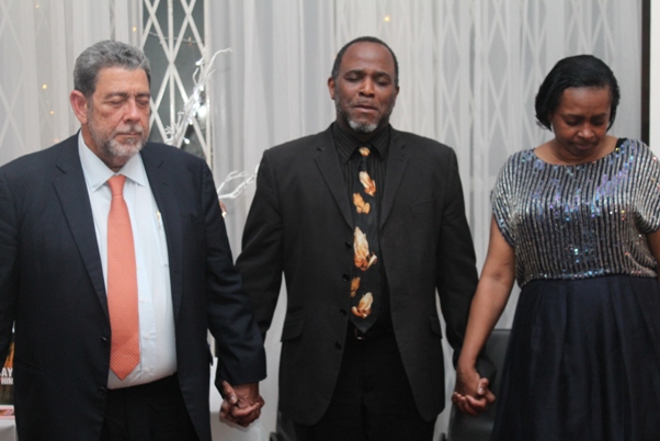Adrian Jones leading closing prayer with Doris and PM Gonsalves. Photo courtesy David F. Roberts / CaribDirect
