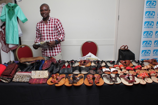 Cobbler and leather craftsman Albert Muange shows off his hand made products. Photo courtesy David F. Roberts