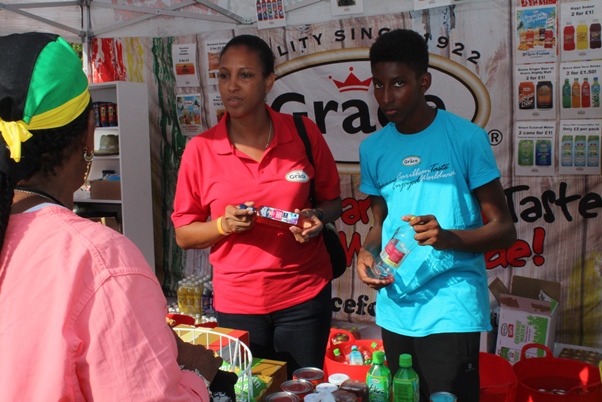 Grace Foods UK marketing manager Nyree Chamber assisted by her son at Grace Foods Stall. Photo courtesy CaribDirect