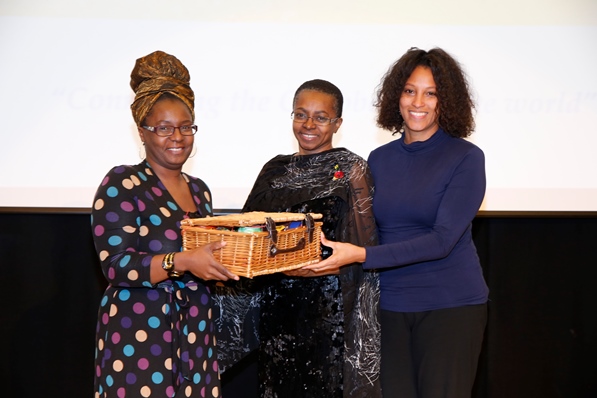 Mrs Carol Vaughan-Roberts, administrative director for CaribDirect and Mrs Nyree Chambers of Grace Foods UK presenting Mrs Doris Charles her gift basket. Photo courtesy CaribDirect