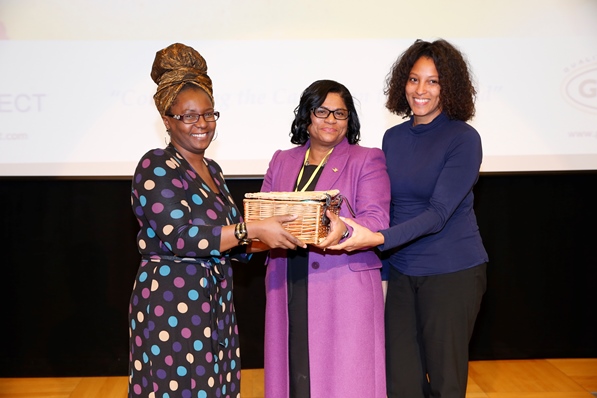 Mrs Carol Vaughan-Roberts, administrative director for CaribDirect and Mrs Nyree Chambers of Grace Foods UK presenting Ms Beverley Awonaya her gift basket. Photo courtesy CaribDirect