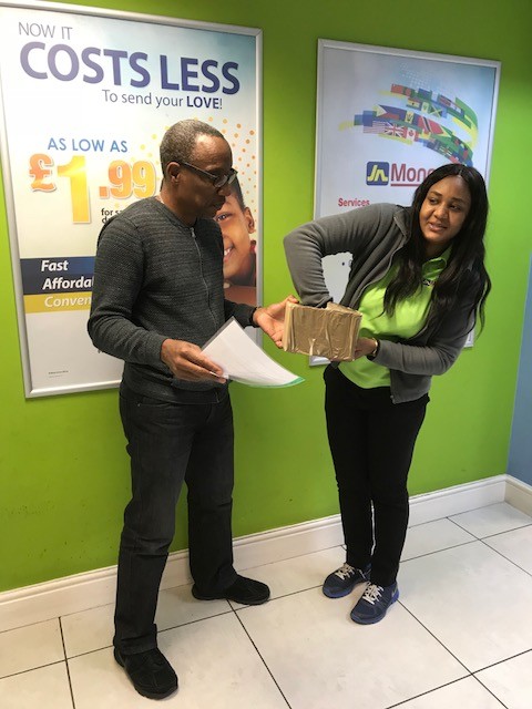 Caribbean Christmas Quiz sponsor JN Money representative Kimona Wilson picks the three luck winners with CaribDirect CEO David F. Roberts